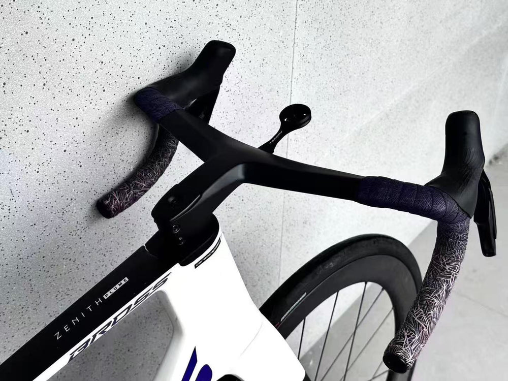 TOCCAY handlebar installed on white road bicycle against concrete wall